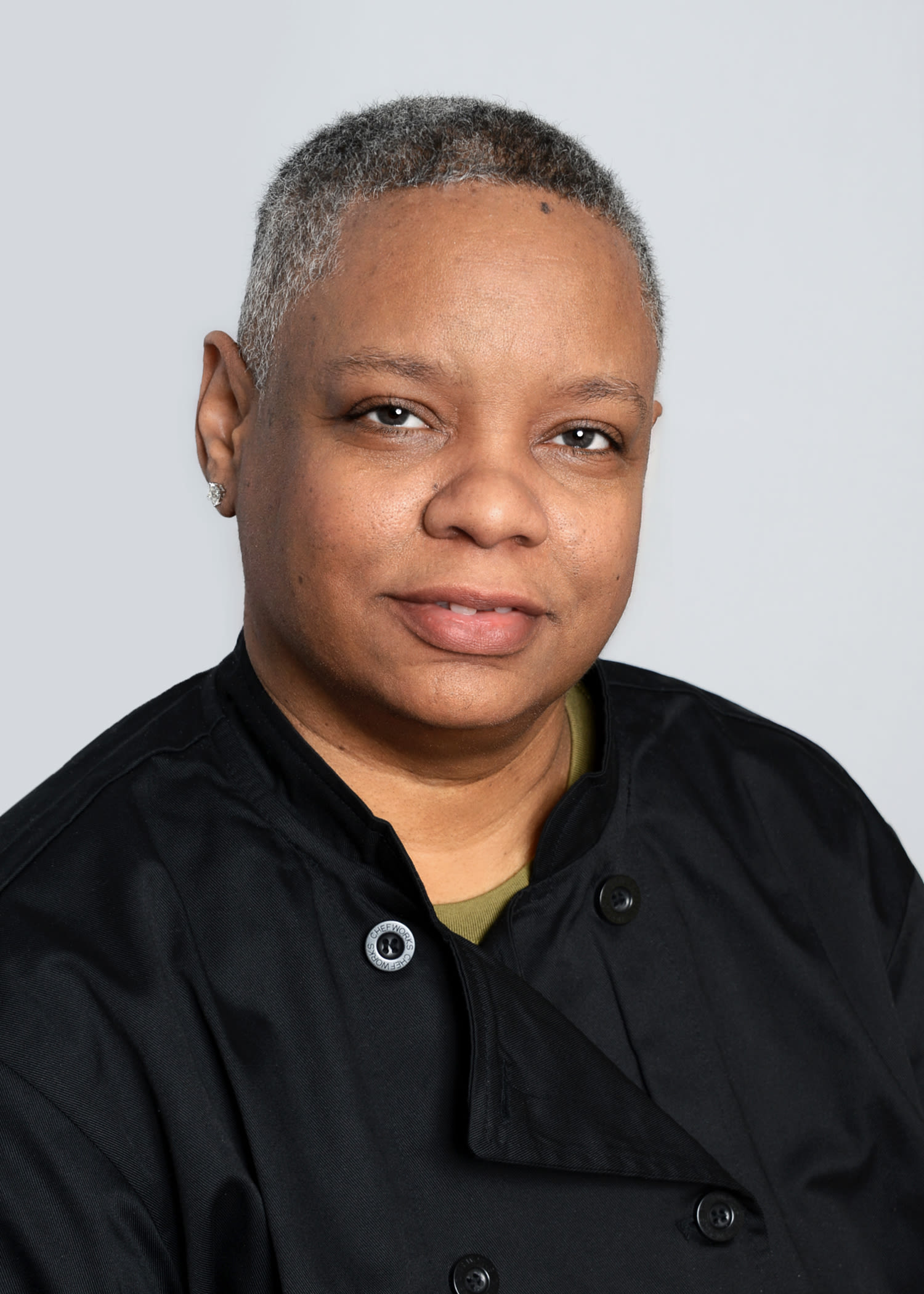 Professional chef portrait with short gray hair