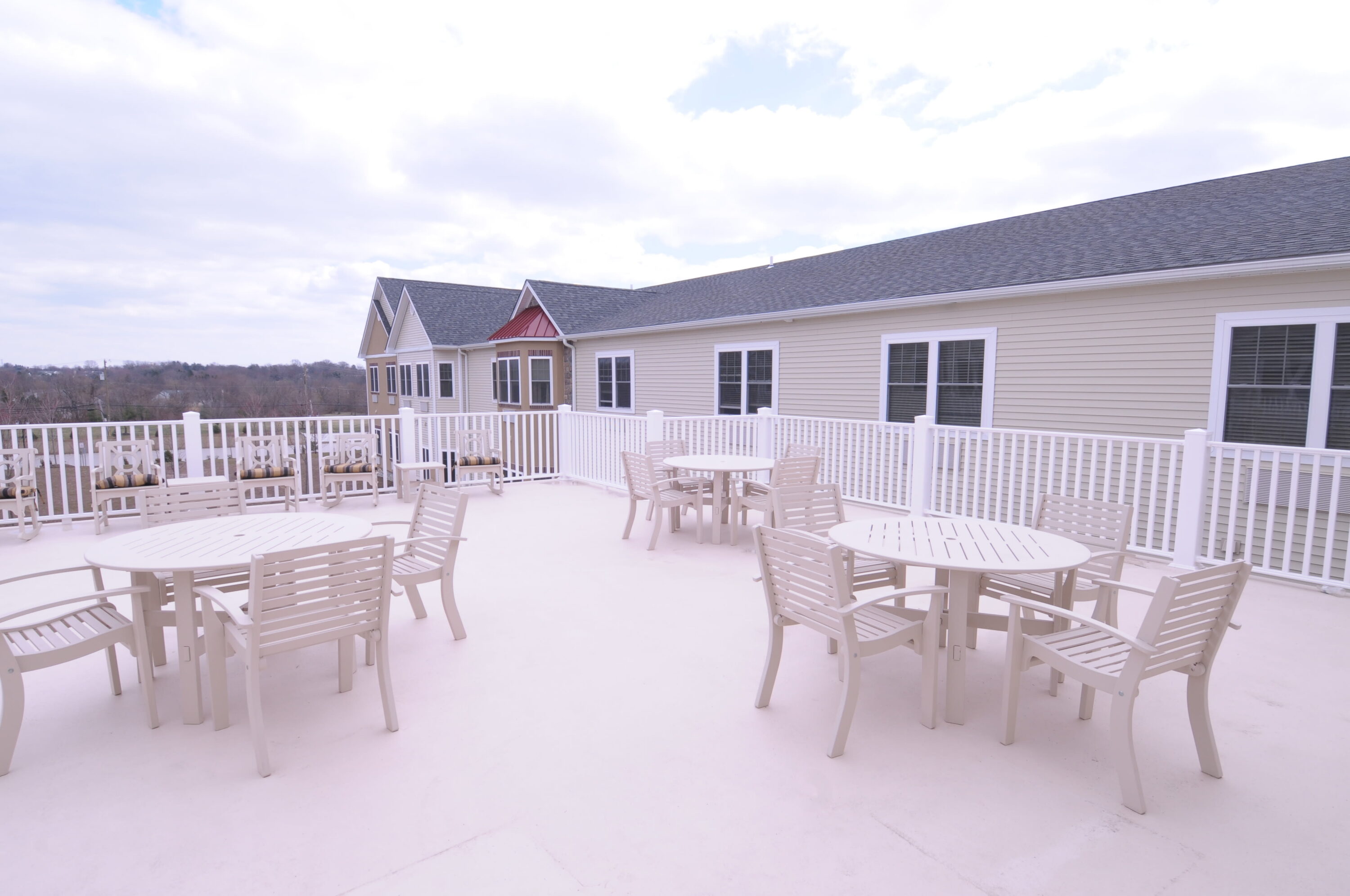 Spacious outdoor deck with tables and chairs